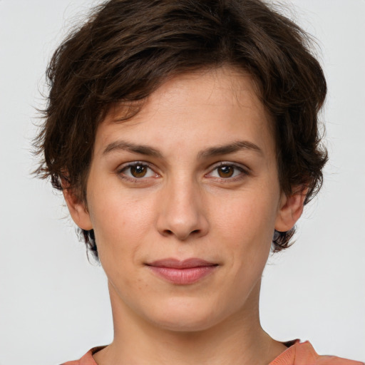 Joyful white young-adult female with short  brown hair and green eyes