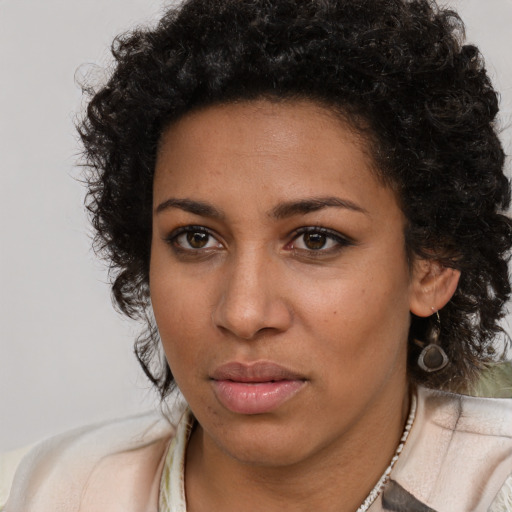 Neutral black young-adult female with medium  brown hair and brown eyes
