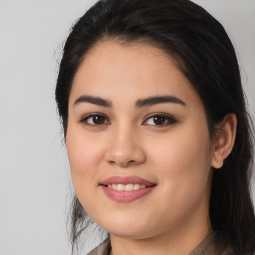Joyful white young-adult female with long  black hair and brown eyes
