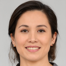 Joyful white young-adult female with medium  brown hair and brown eyes