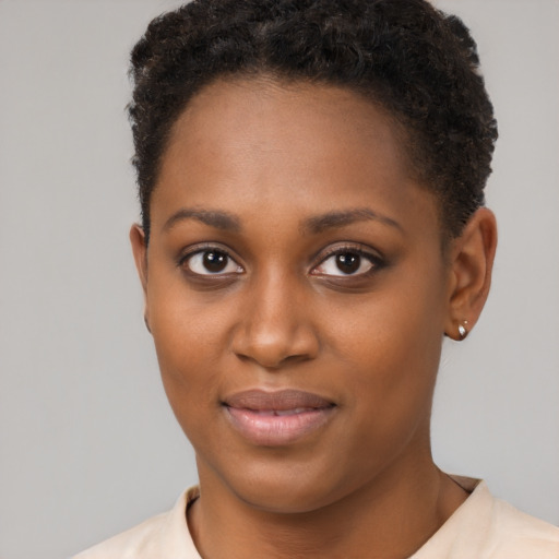Joyful black young-adult female with short  brown hair and brown eyes