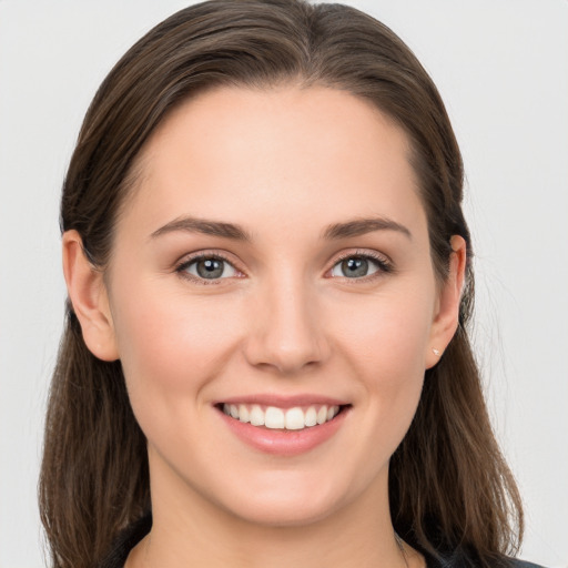 Joyful white young-adult female with long  brown hair and grey eyes