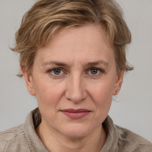 Joyful white adult female with medium  brown hair and blue eyes