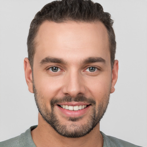 Joyful white young-adult male with short  brown hair and brown eyes