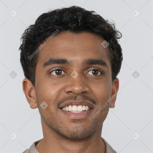 Joyful black young-adult male with short  brown hair and brown eyes