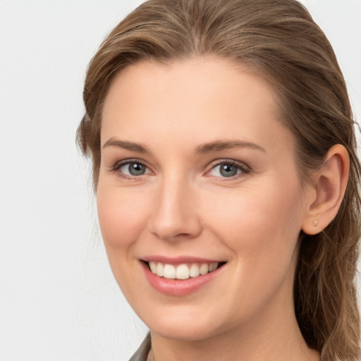 Joyful white young-adult female with long  brown hair and grey eyes