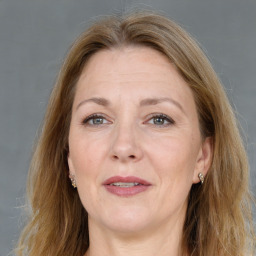 Joyful white adult female with medium  brown hair and grey eyes