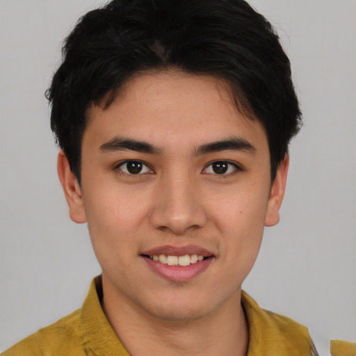 Joyful asian young-adult male with short  brown hair and brown eyes