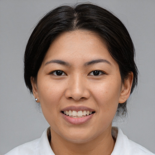 Joyful asian young-adult female with medium  brown hair and brown eyes