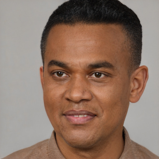 Joyful black young-adult male with short  black hair and brown eyes