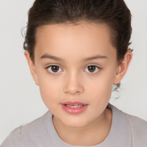 Joyful white child female with short  brown hair and brown eyes