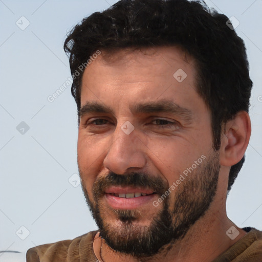 Joyful white adult male with short  black hair and brown eyes