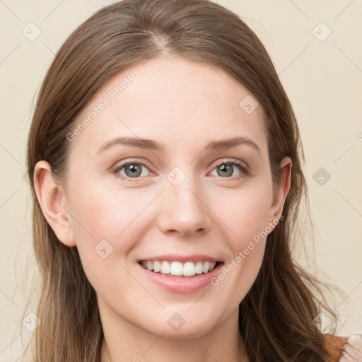 Joyful white young-adult female with long  brown hair and blue eyes