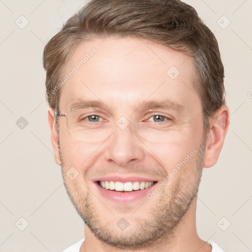 Joyful white adult male with short  brown hair and grey eyes