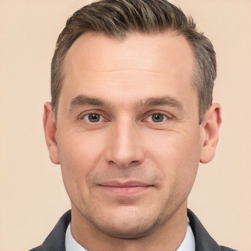 Joyful white adult male with short  brown hair and brown eyes