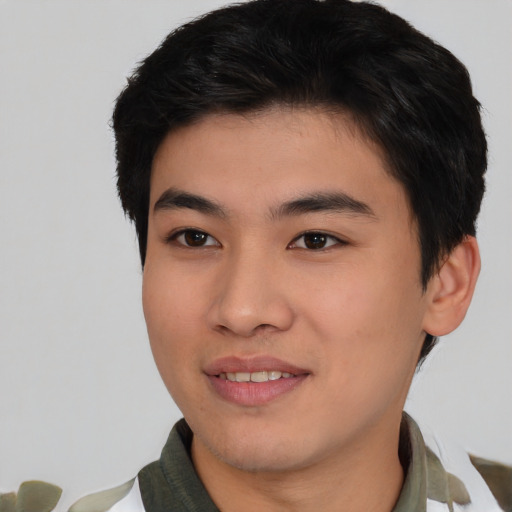 Joyful asian young-adult male with short  black hair and brown eyes