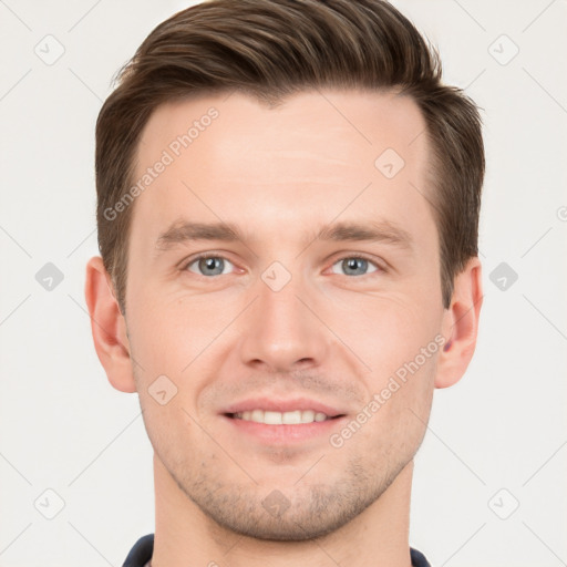 Joyful white young-adult male with short  brown hair and grey eyes