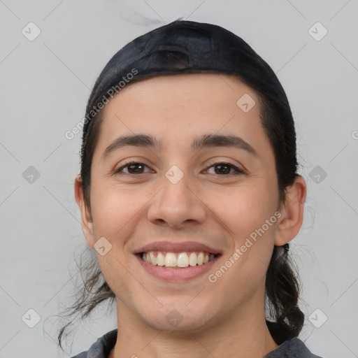 Joyful white young-adult female with medium  black hair and brown eyes