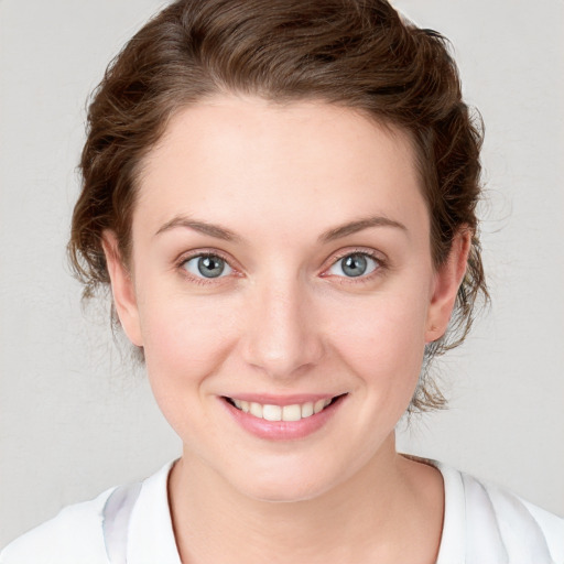 Joyful white young-adult female with medium  brown hair and blue eyes