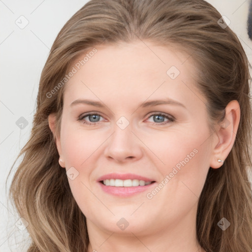 Joyful white young-adult female with long  brown hair and blue eyes