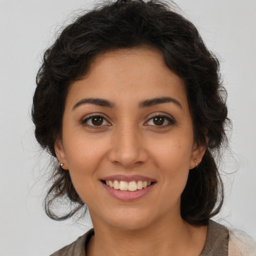 Joyful latino young-adult female with long  brown hair and brown eyes