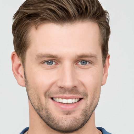 Joyful white young-adult male with short  brown hair and grey eyes