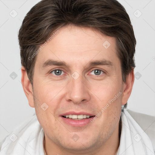 Joyful white adult male with short  brown hair and grey eyes