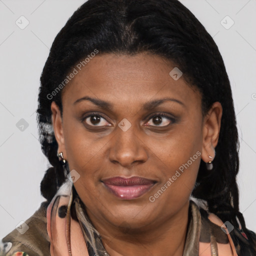 Joyful black adult female with long  brown hair and brown eyes