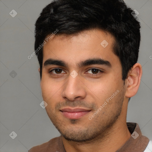Joyful white young-adult male with short  black hair and brown eyes