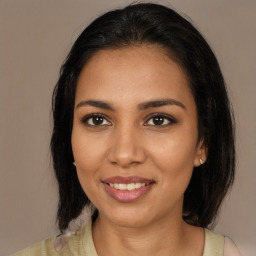 Joyful latino young-adult female with medium  black hair and brown eyes