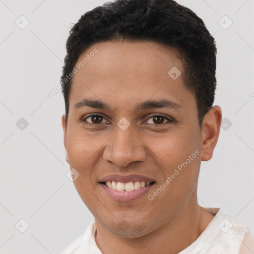 Joyful latino young-adult male with short  black hair and brown eyes