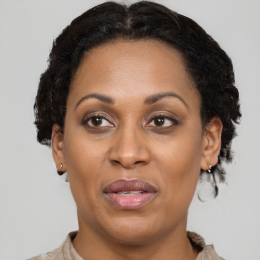 Joyful latino adult female with short  brown hair and brown eyes