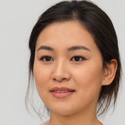 Joyful asian young-adult female with medium  brown hair and brown eyes