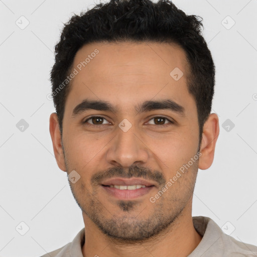 Joyful latino young-adult male with short  black hair and brown eyes