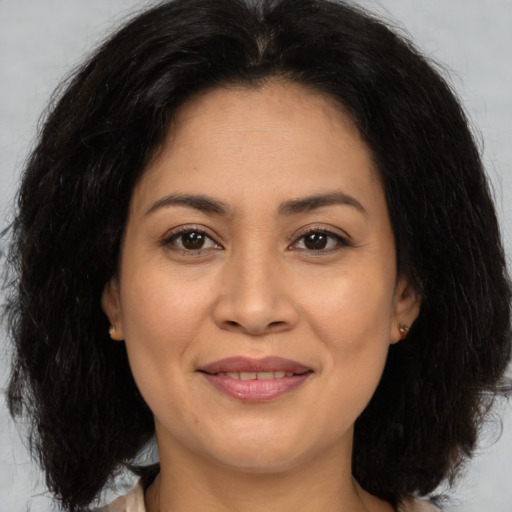 Joyful asian adult female with medium  brown hair and brown eyes
