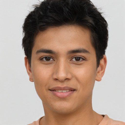 Joyful latino young-adult male with short  brown hair and brown eyes