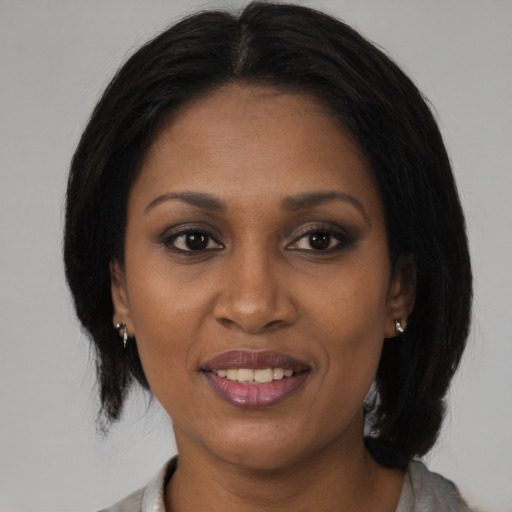 Joyful black young-adult female with medium  brown hair and brown eyes