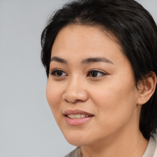 Joyful white young-adult female with medium  black hair and brown eyes