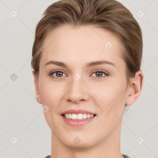 Joyful white young-adult female with short  brown hair and grey eyes