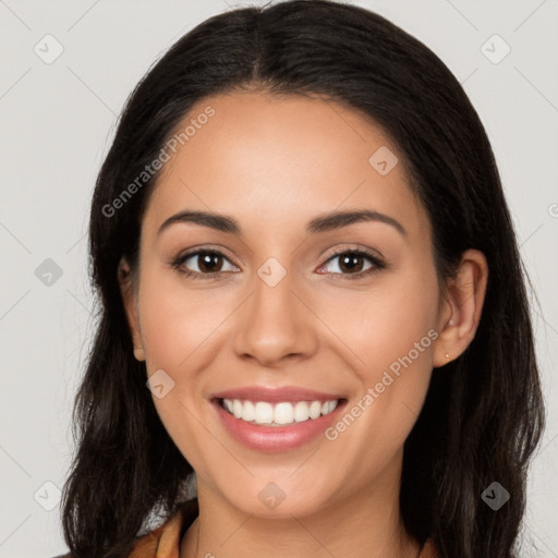 Joyful latino young-adult female with long  brown hair and brown eyes