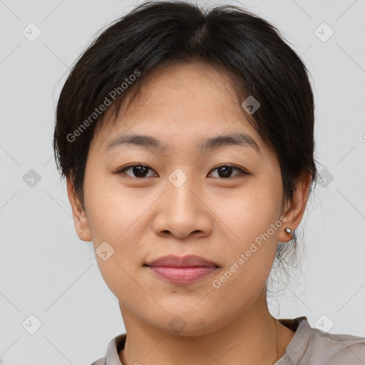 Joyful asian young-adult female with short  brown hair and brown eyes