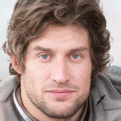 Joyful white young-adult male with short  brown hair and blue eyes