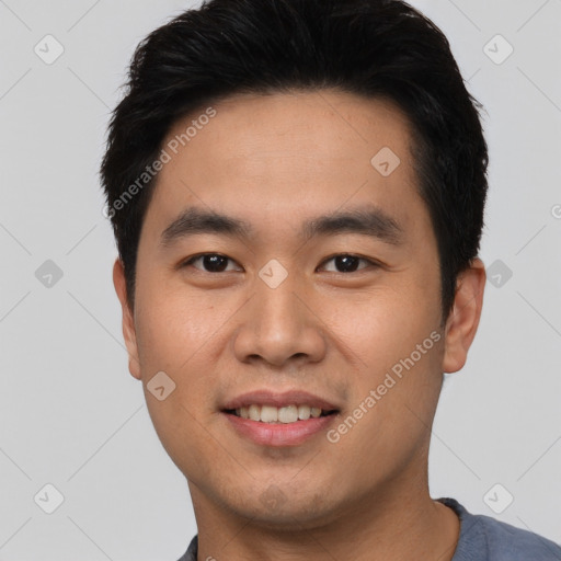 Joyful asian young-adult male with short  black hair and brown eyes