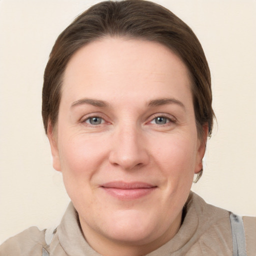 Joyful white adult female with medium  brown hair and grey eyes