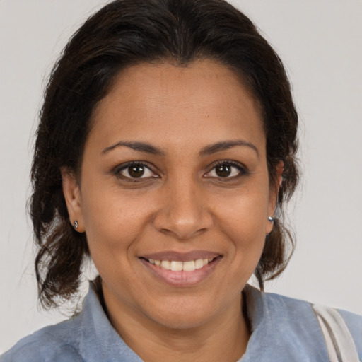 Joyful black young-adult female with medium  brown hair and brown eyes