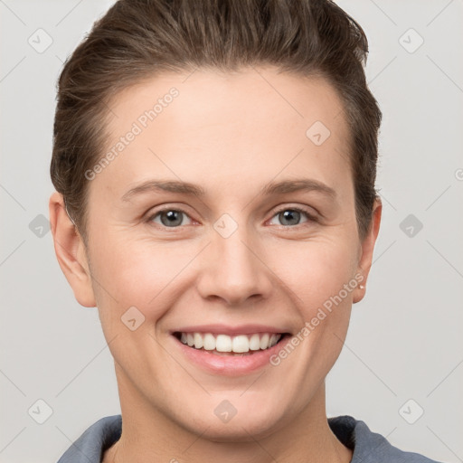 Joyful white young-adult female with short  brown hair and grey eyes