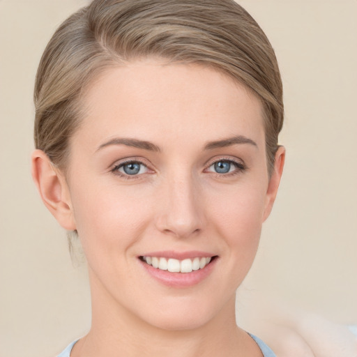 Joyful white young-adult female with short  brown hair and blue eyes