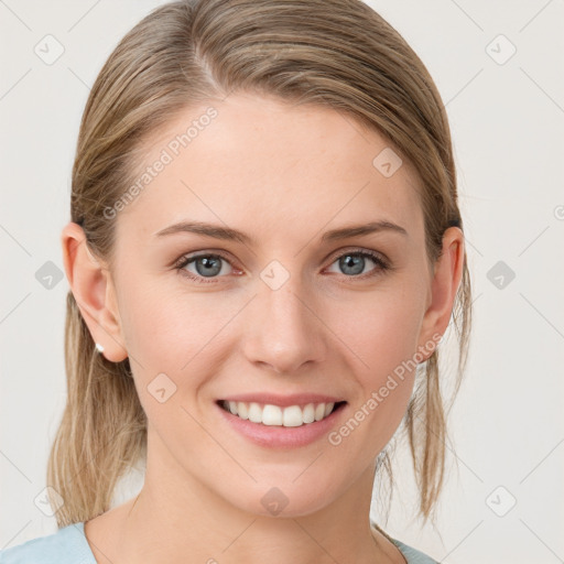 Joyful white young-adult female with medium  brown hair and blue eyes