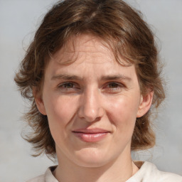 Joyful white adult female with medium  brown hair and blue eyes