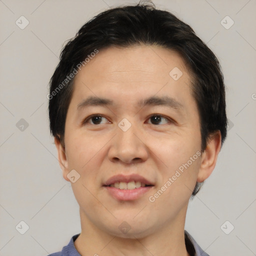 Joyful asian young-adult male with short  black hair and brown eyes